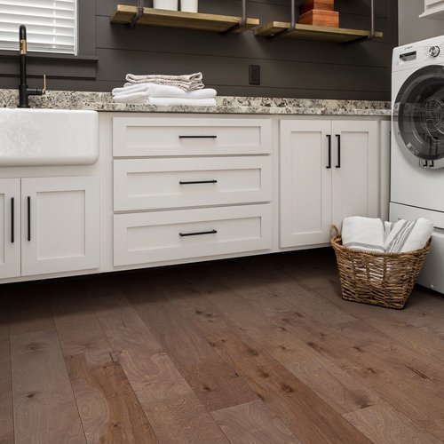 white bathroom cabinets and brown hardwood floor from Roedigers Custom Flooring in Celina, OH